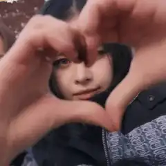 Girl making heart hands with friend