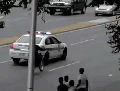 motorcyclist rides on police car