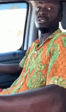 Man in car laughing hysterically