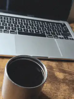 coffee cup and laptop on desk