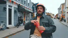 Man spits out hot liquid from thermos