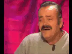 Man laughing hysterically at a table