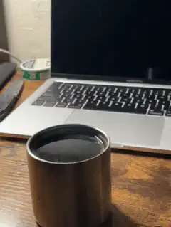 metal cup on desk with laptop
