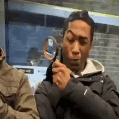 Man looking through magnifying glass