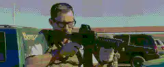 man aiming rifle with pixelated filter