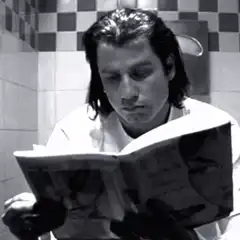 John Travolta reading a book