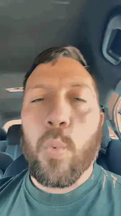 man in car making kissing face