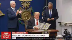 Trump holds up Pokemon cards