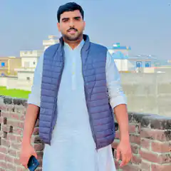 Man in white kurta and blue vest