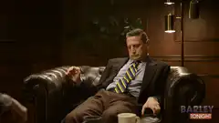 Man in suit looking at phone