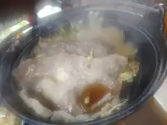 steaming hot pot with meat and vegetables