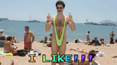Man in neon green speedo on beach