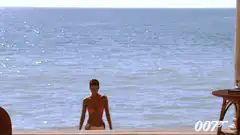Honey Ryder walking out of the sea