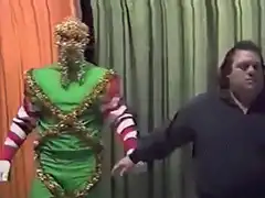 Man in green elf costume with gold tinsel