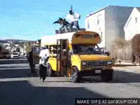 Men jumping on school bus roof