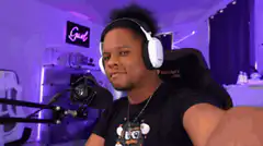 Man in gaming chair smirking at camera