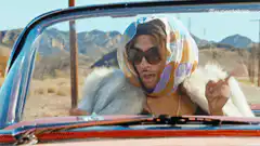 Beyonce in a car pointing fingers