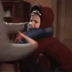 Boy getting wrapped in a scarf