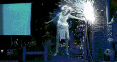 Woman holding sparkler at night