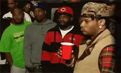 Man holding red cup looking skeptical