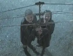 Two boys holding a TV antenna in the rain
