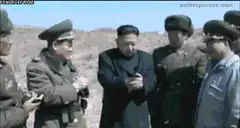 Kim Jong Un fires a pistol with a bang