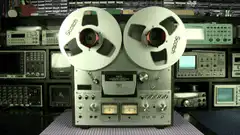 Vintage reel-to-reel tape recorder spinning