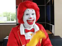 Ronald McDonald points and laughs