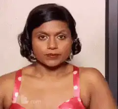 Woman in pink polka dot top smiles