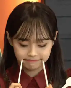 Girl holding chopsticks in mouth