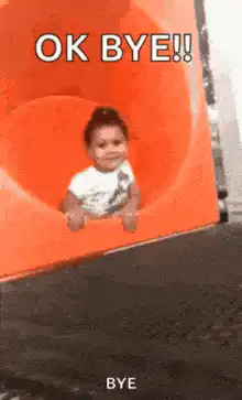 Baby sliding down orange slide