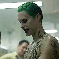 Joker looking down with tattoos