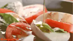 Olive oil drizzled on caprese salad