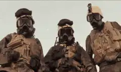 Three soldiers in gas masks nodding