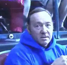 Kevin Spacey in blue hoodie smiling