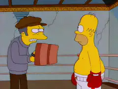 Homer punches a pad in the boxing ring
