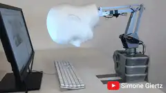 Robotic head typing on keyboard