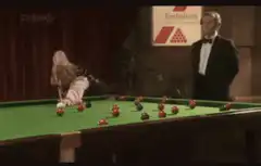 Woman playing snooker with man watching