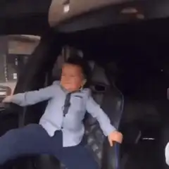 Baby in suit driving car