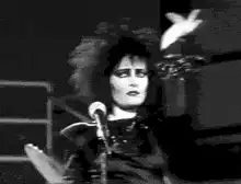 Siouxsie Sioux singing on stage