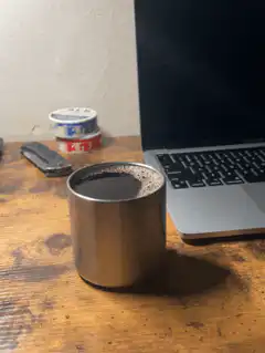 steaming metal cup on desk