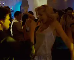 Blonde woman dancing at a party