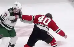 Hockey players fighting on ice