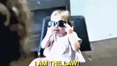Toddler in sunglasses says I am the law