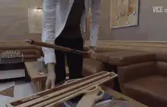 Man assembles wooden pool cue