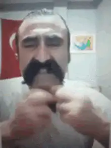 Mustached man pulls shirt over head