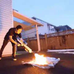 man using flamethrower on paper