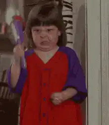 Angry toddler girl with purple brush