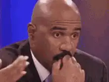 Steve Harvey touching his mustache