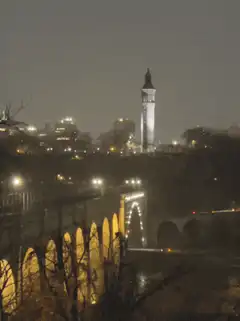 night cityscape with clock tower and bridge